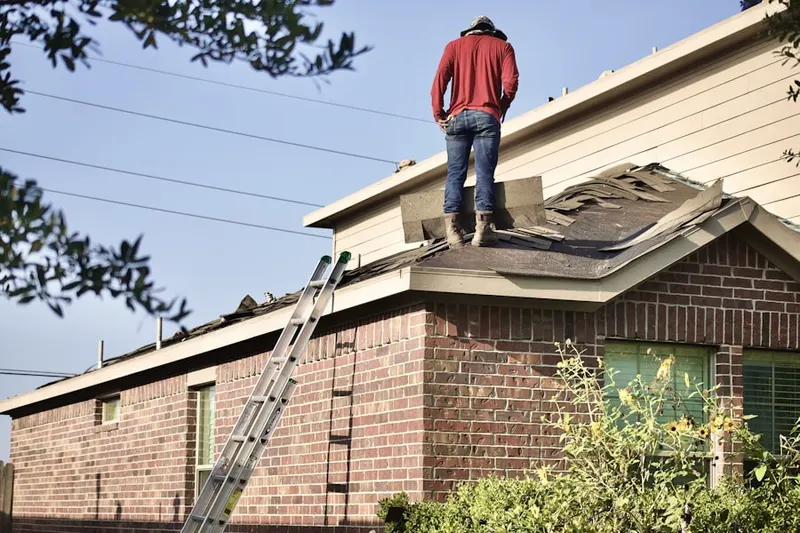 Professional roofer working on a residential roof in Indian Oaks Estates